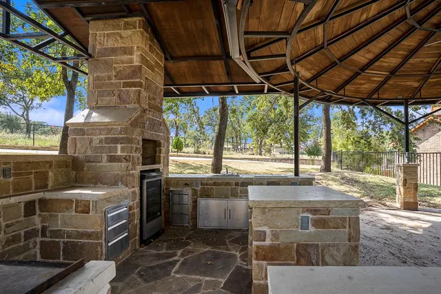 a kitchen with stainless steel appliances granite countertop a sink and a counter