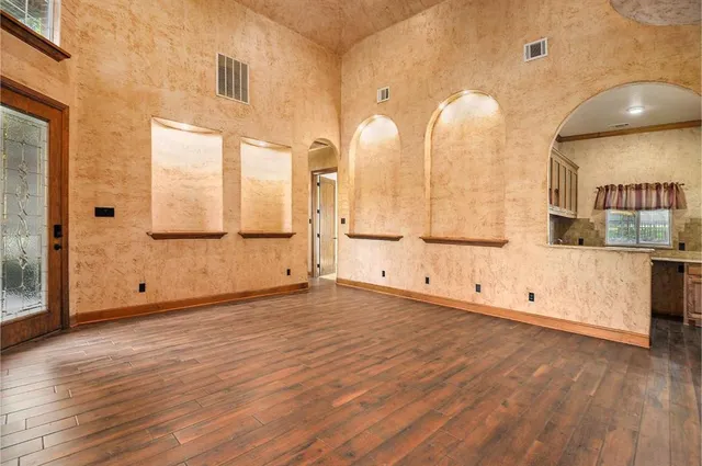 a view of a kitchen with wooden floor and windows