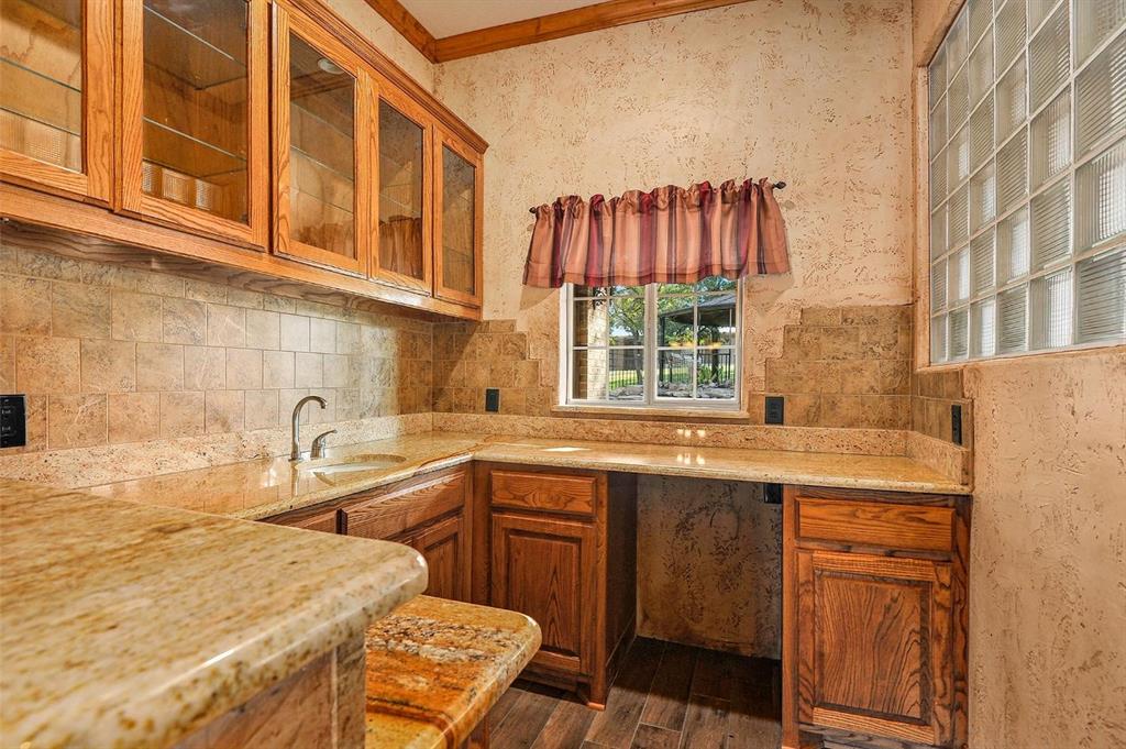 112 Bonita Drive Springtown, TX 76082 - Photo 8 of 39 a kitchen with a sink and a stove top oven