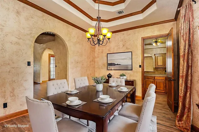 a dining room with furniture a chandelier and window