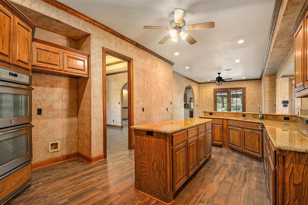 112 Bonita Drive Springtown, TX 76082 - Photo 10 of 39 a kitchen with stainless steel appliances granite countertop a stove and a refrigerator