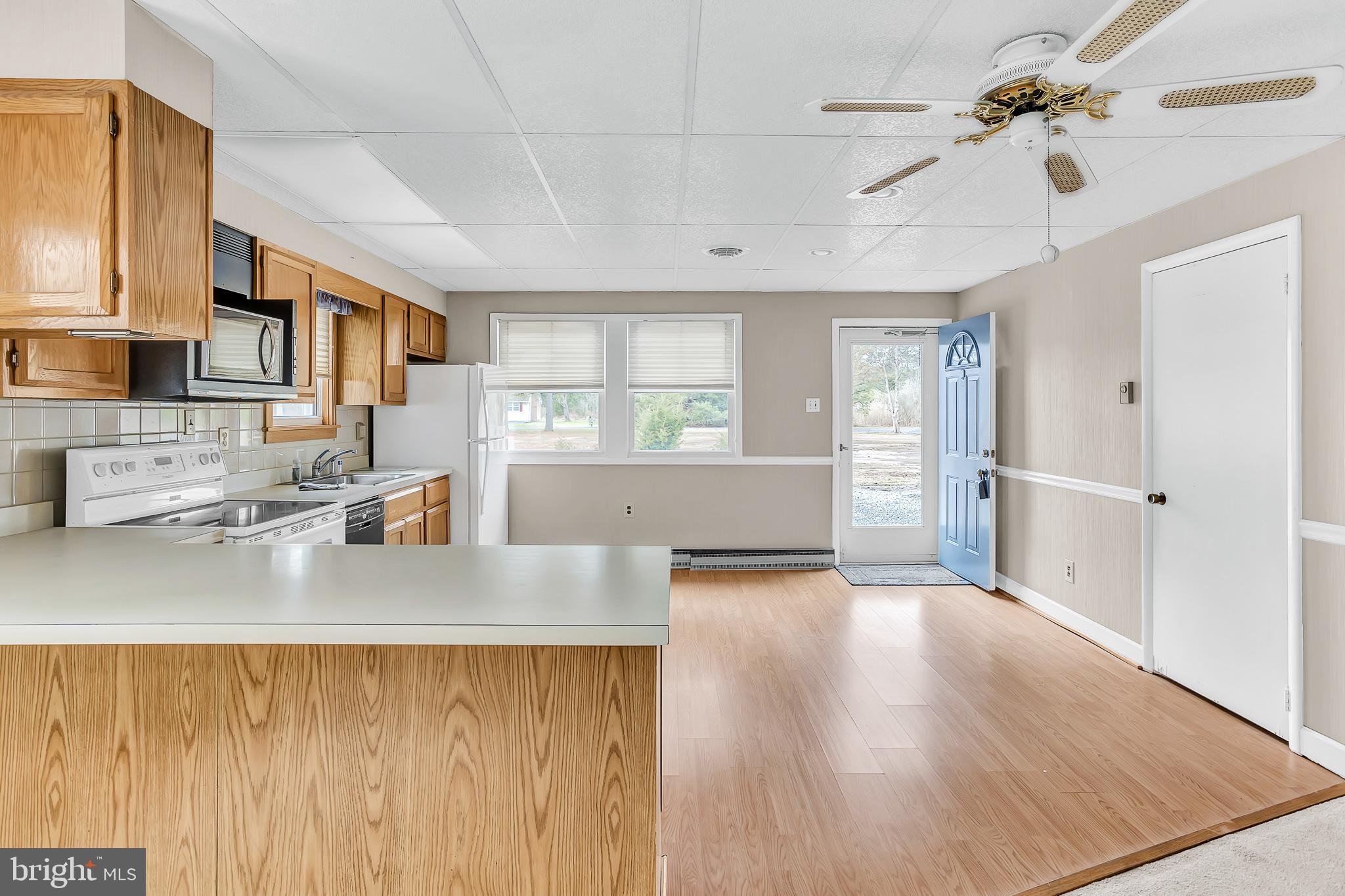 26919 Fitzgerald Road Princess Anne, MD 21853 - Photo 23 of 84 a kitchen with stainless steel appliances granite countertop a sink dishwasher stove top oven and cabinets with wooden floor