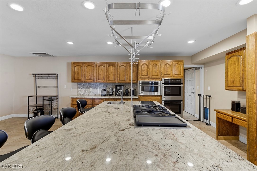 1870 East Viking Road Las Vegas, NV 89169 - Photo 13 of 44 Massive island in the kitchen with a down-draft vented stove top- dual ovens and microwave
