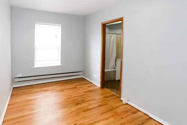 a view of a room with a wooden floor and a window