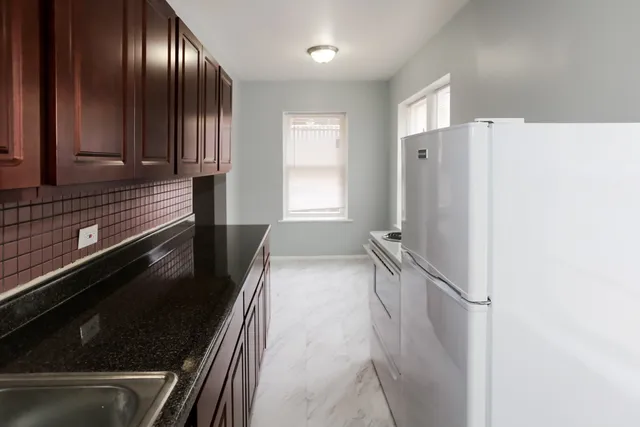 a view of an empty room and wooden floor