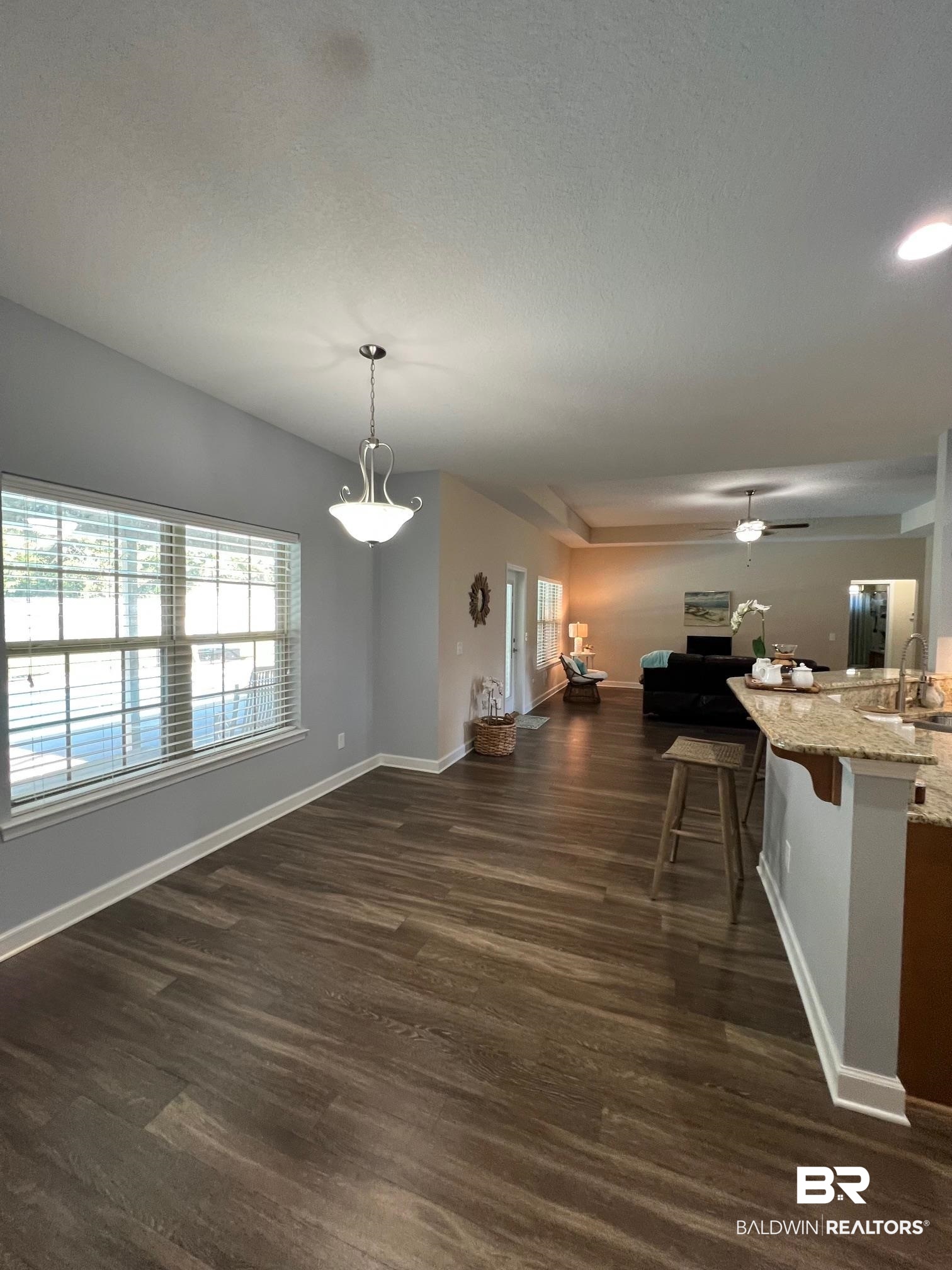 10257 Lyttleton Loop Lillian, AL 36549 - Photo 12 of 31 Dining room with dark wood-type flooring and a textured ceiling