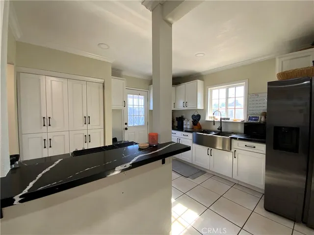 a large white kitchen with a large window