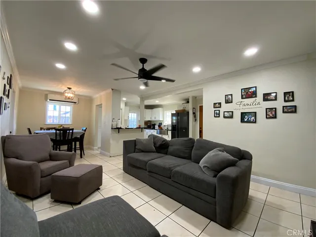 a living room with furniture and a ceiling fan