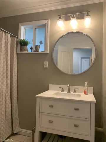 a bathroom with a sink mirror and vanity