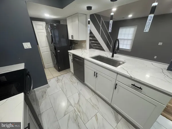 a kitchen with stainless steel appliances kitchen island granite countertop a sink a stove and cabinets