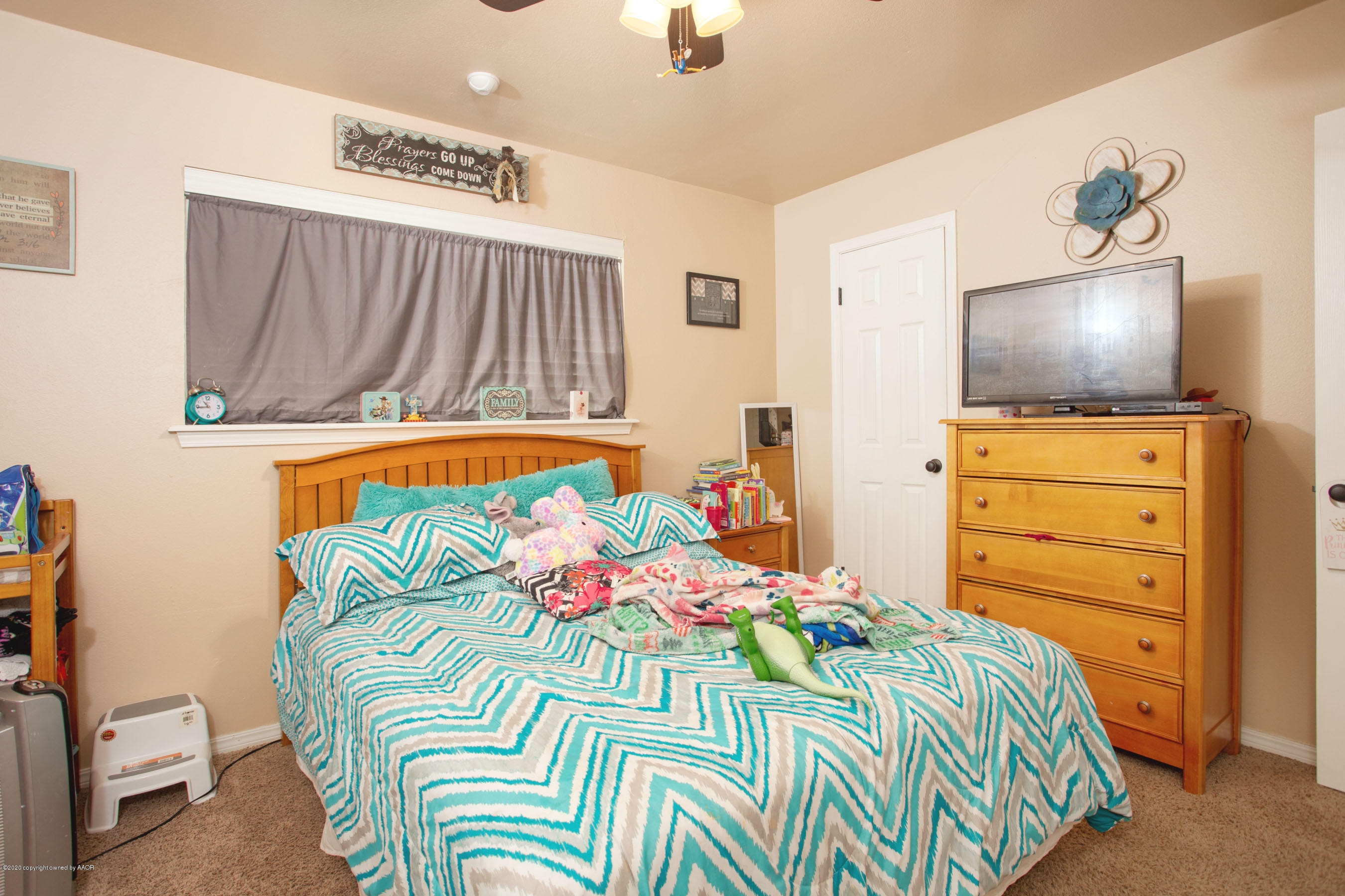 4215 South Monroe Street Amarillo, TX 79110 - Photo 17 of 27 a bedroom with a bed and a flat screen tv