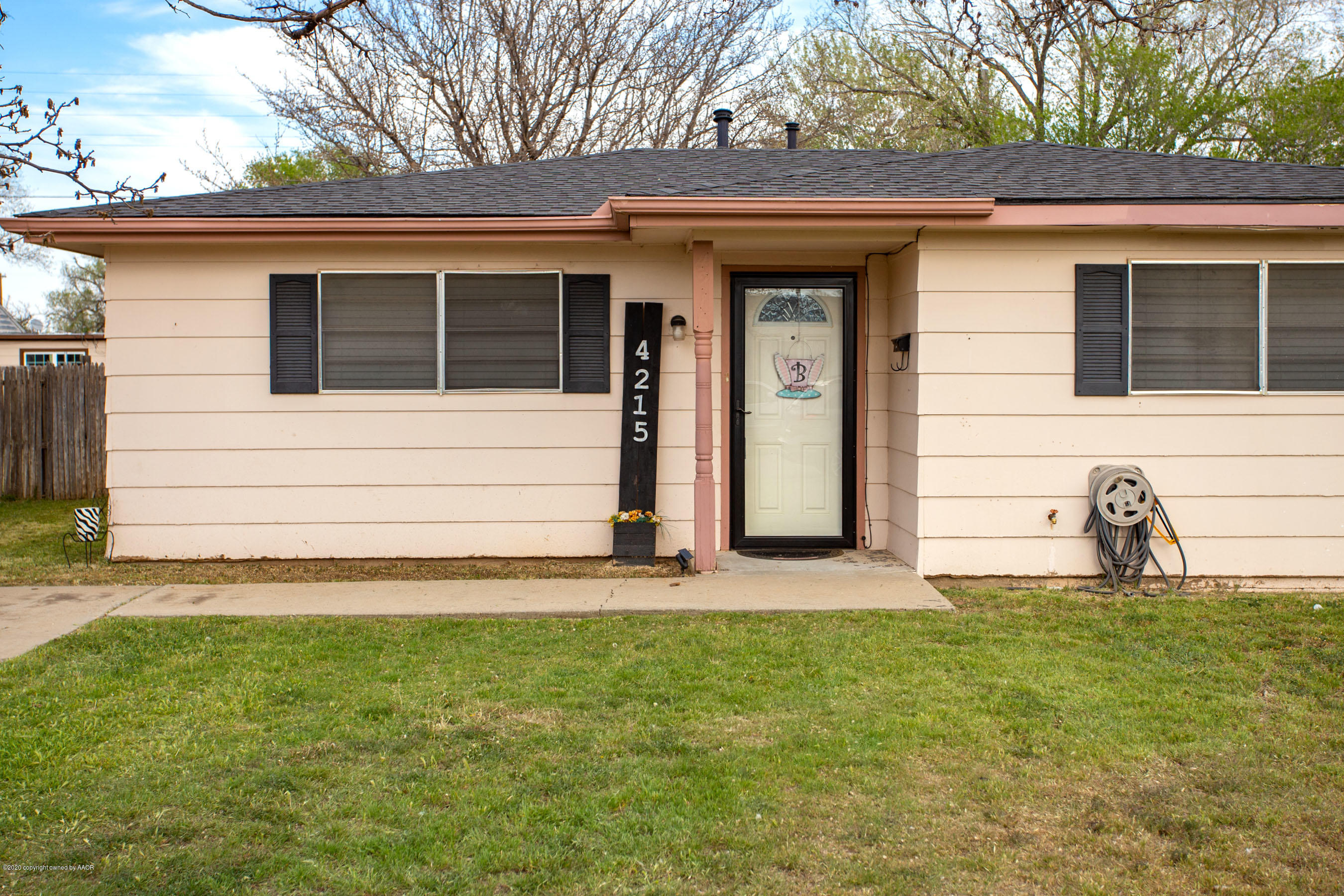 4215 South Monroe Street Amarillo, TX 79110 - Photo 2 of 27 a front view of a house with a yard