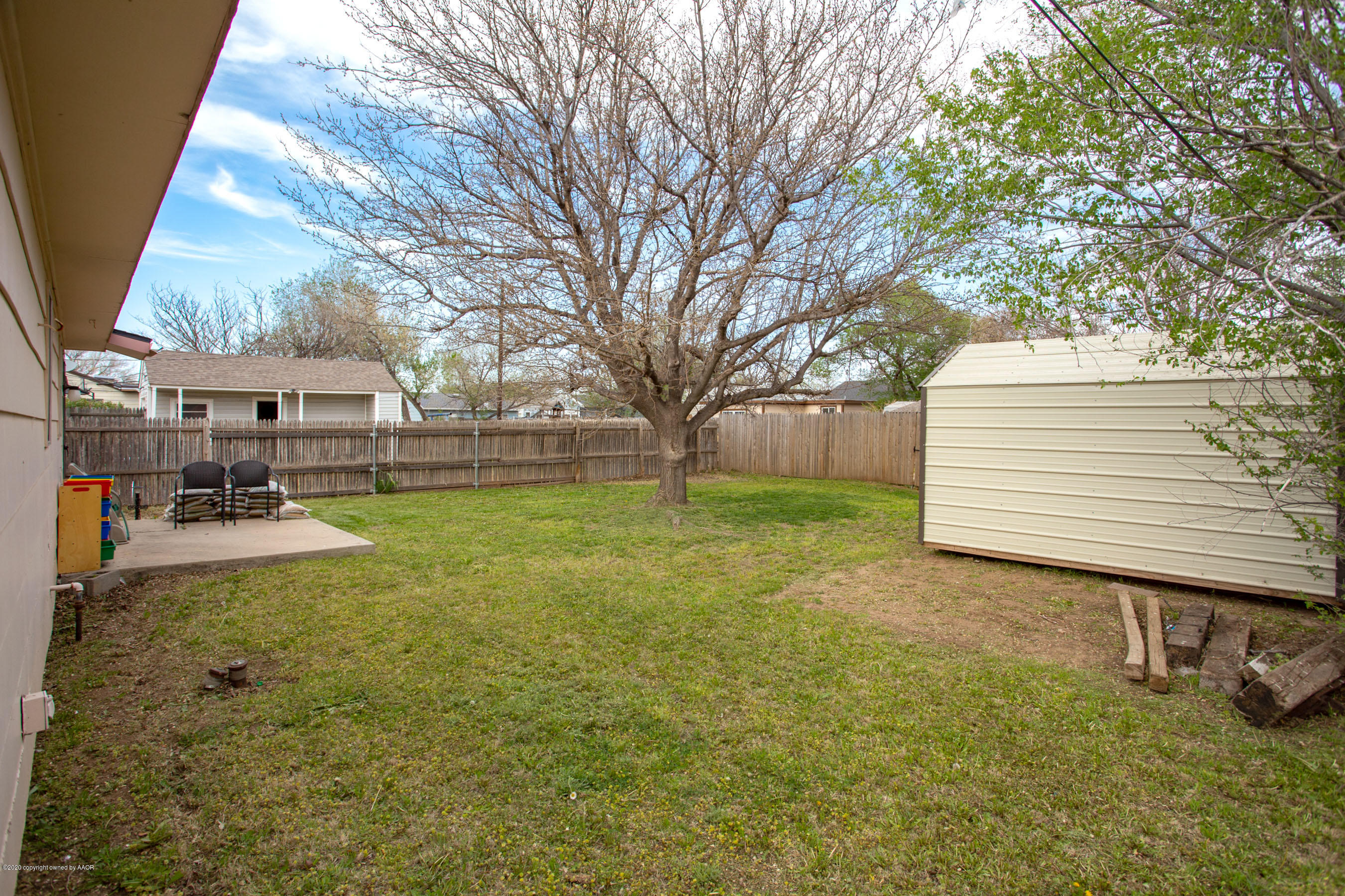 4215 South Monroe Street Amarillo, TX 79110 - Photo 23 of 27 a view of a yard with a house and a large tree