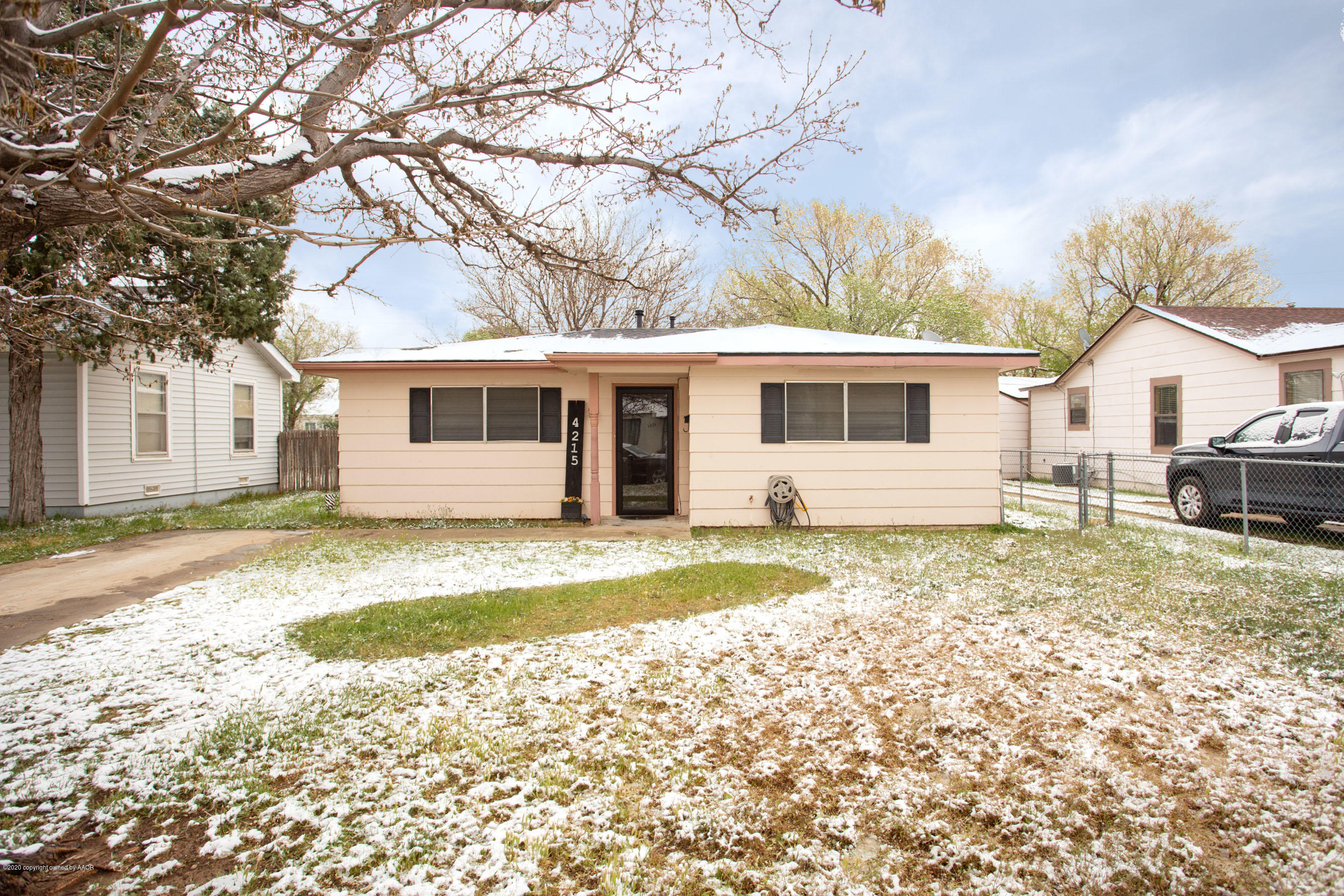 4215 South Monroe Street Amarillo, TX 79110 - Photo 4 of 27 a view of a yard with a house and a tree