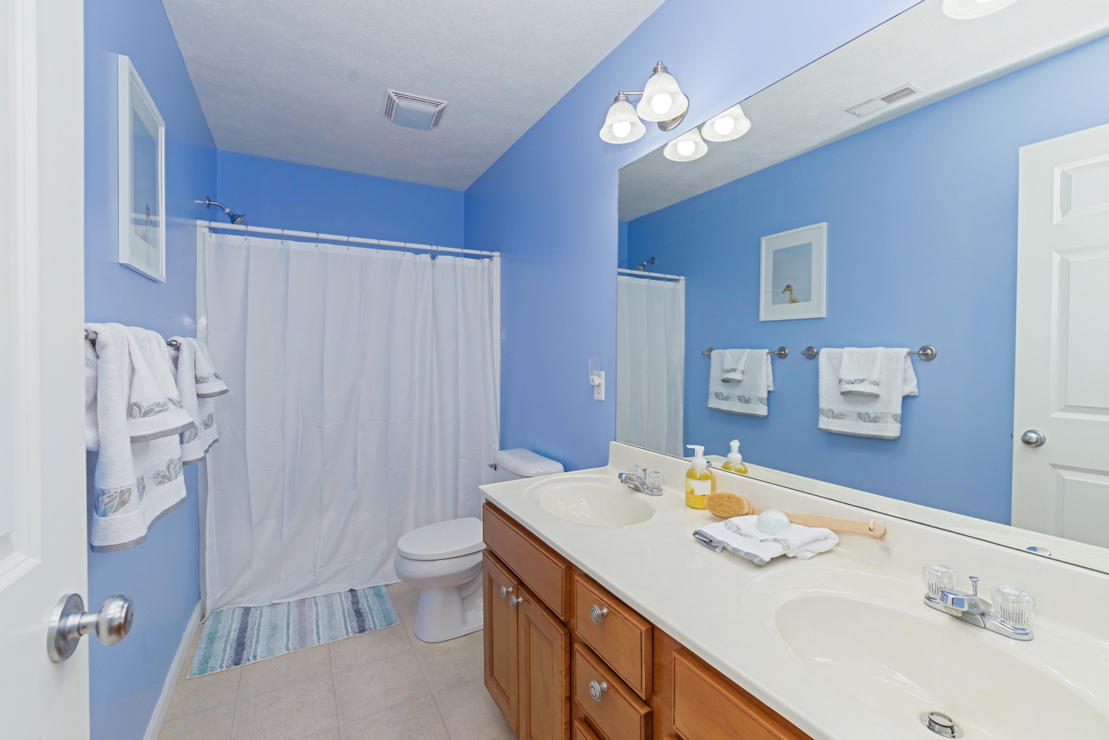 1611 Belclare Road Normal, IL 61761 - Photo 17 of 34 a bathroom with a sink a toilet a light fixture and a mirror