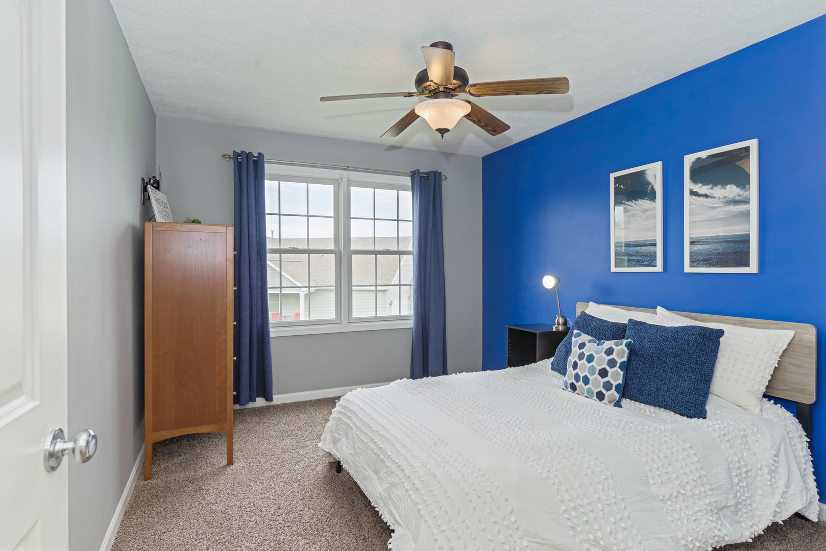 1611 Belclare Road Normal, IL 61761 - Photo 21 of 34 a bedroom with a large bed and a chandelier