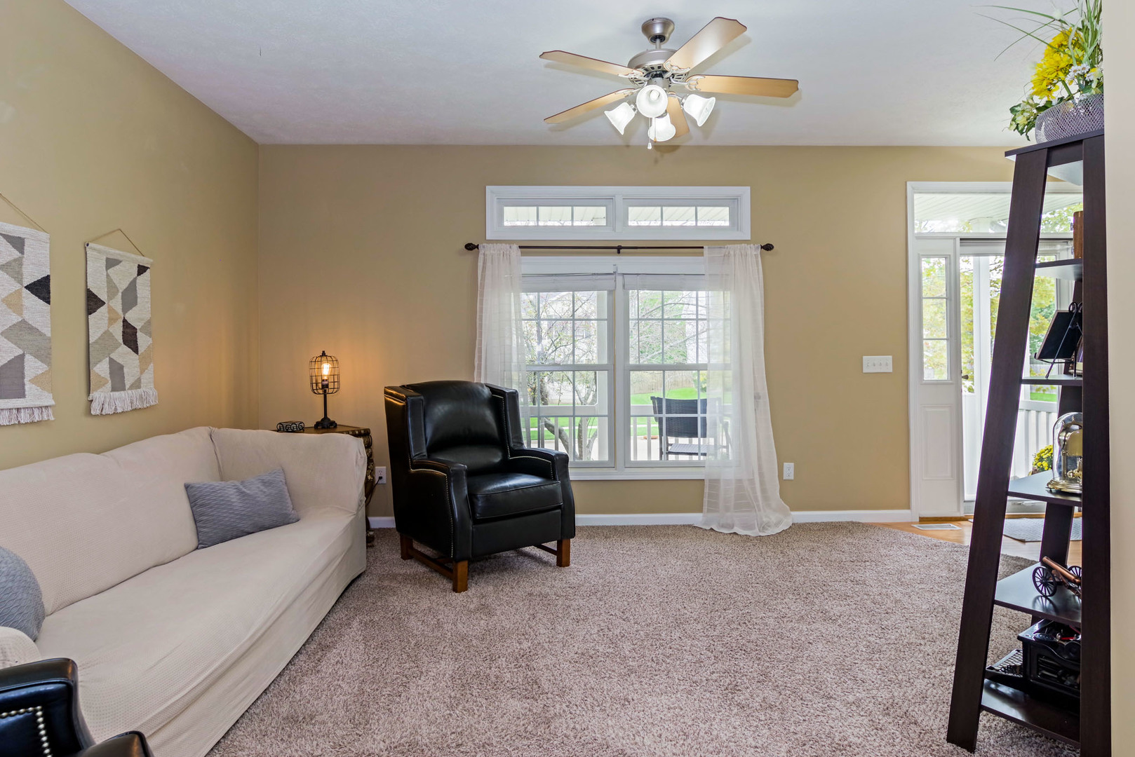 1611 Belclare Road Normal, IL 61761 - Photo 7 of 34 a living room with furniture a ceiling fan a rug and a window