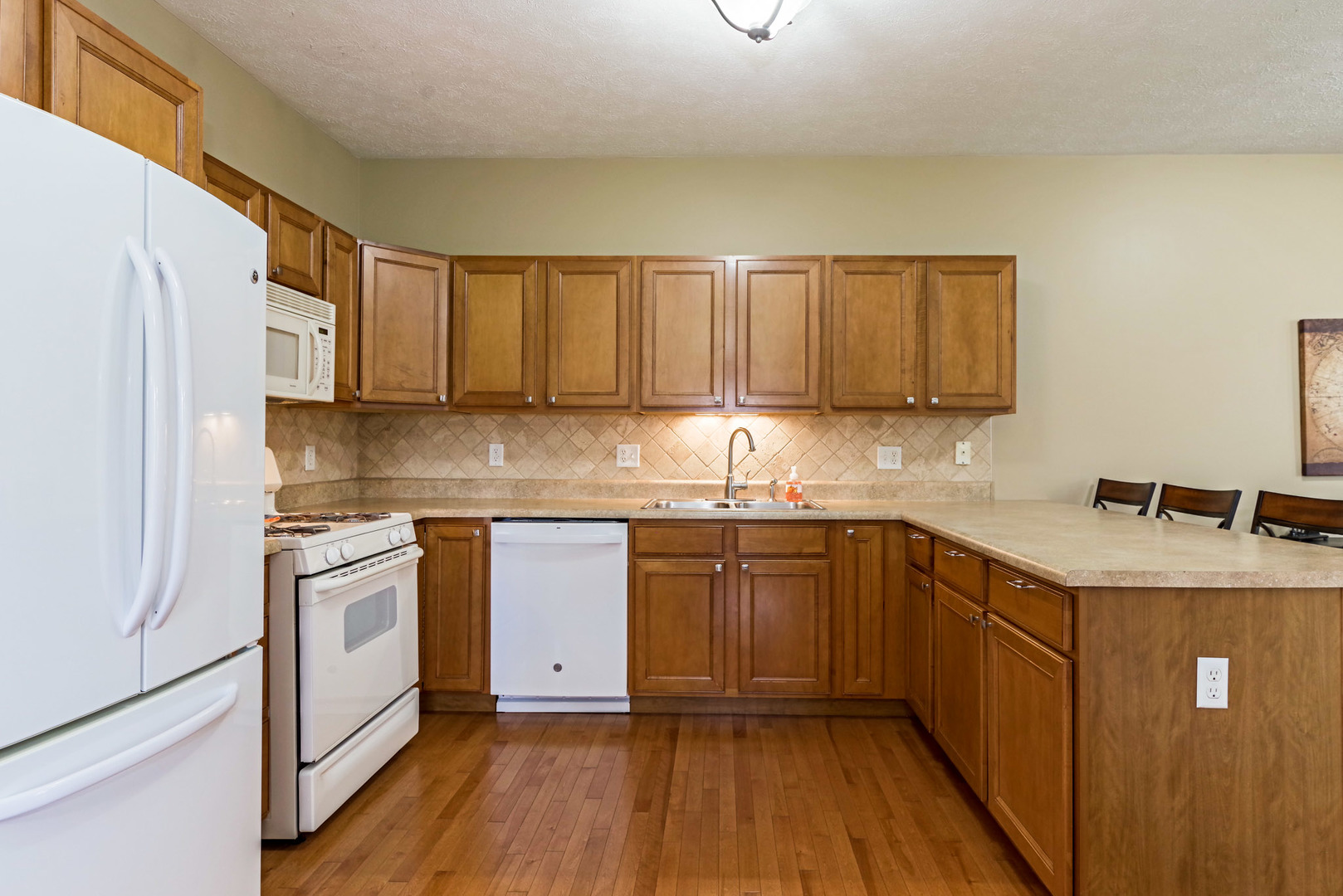 1611 Belclare Road Normal, IL 61761 - Photo 10 of 34 a kitchen with stainless steel appliances granite countertop a sink stove and refrigerator