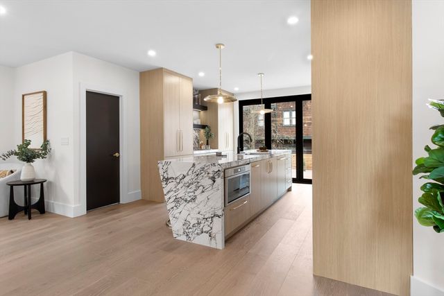 a kitchen with stainless steel appliances kitchen island granite countertop a table and chairs