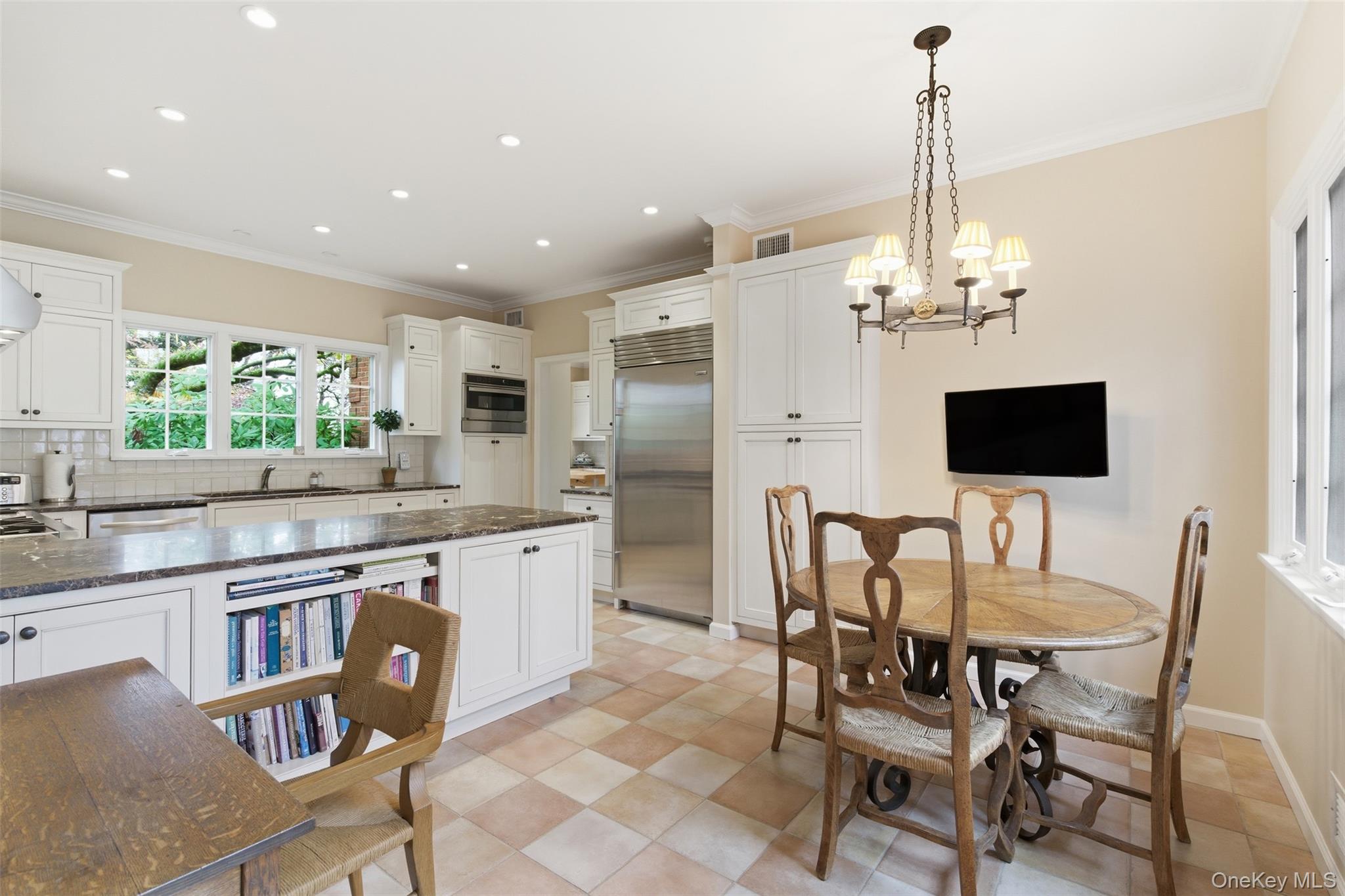 159 Factory Pond Road Mill Neck, NY 11560 - Photo 30 of 39 Main Eat-in Kitchen featuring pendant lighting, dark stone countertops, stainless steel appliances, white cabinets, and ornamental molding