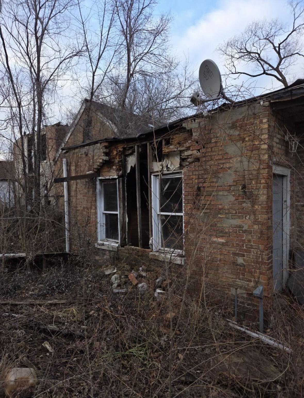 1665 West 12th Avenue Gary, IN 46404 - Photo 5 of 5 a backyard of a house with barbeque oven and large tree