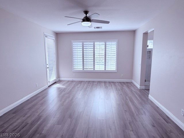19 Mohansic Road Henderson, NV 89052 - Photo 12 of 30 Hardwood floors and a ceiling fan create a comfortable and inviting atmosphere in this room.