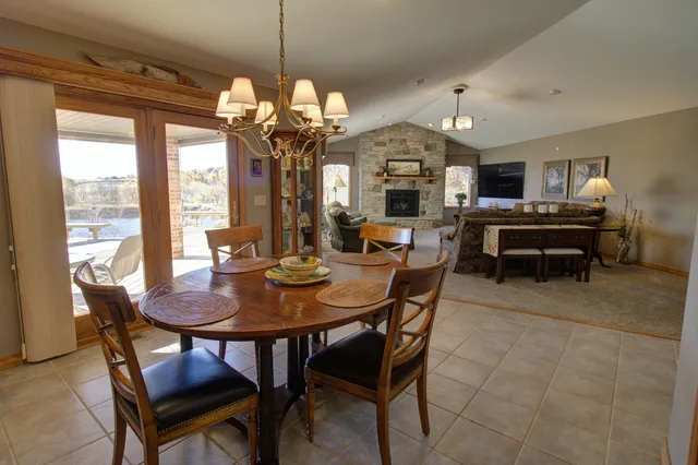 a kitchen with refrigerator a table and chairs