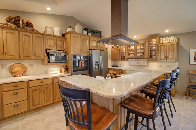 a kitchen with a dining table and chairs