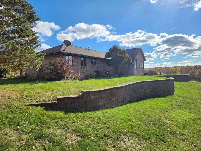 a view of a house with a yard and a fountain