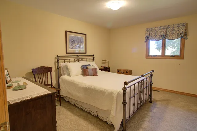 a bedroom with a bed and a night stand