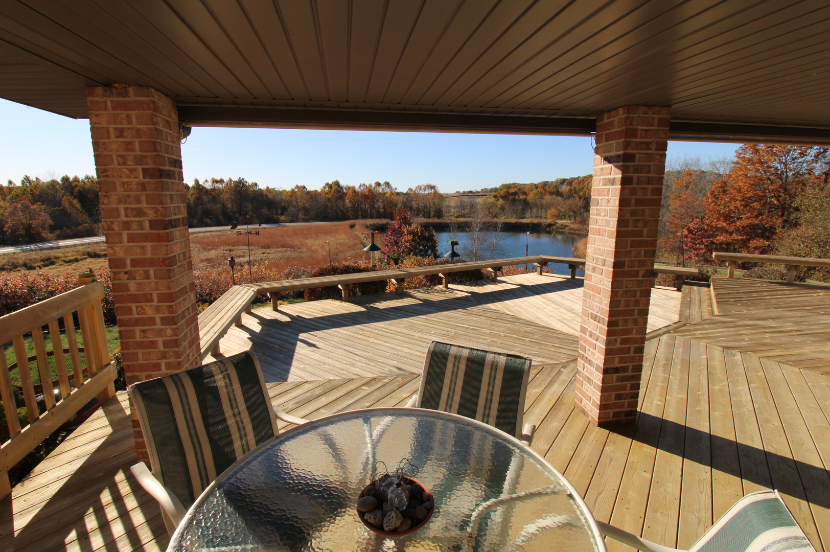 16360 Spring Valley Road Morrison, IL 61270 - Photo 7 of 60 a view of a balcony with couches and wooden floor