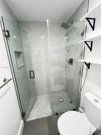 a bathroom with a toilet and a shower