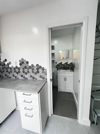 a kitchen with a sink and cabinets