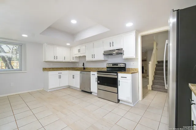 a kitchen with stainless steel appliances cabinets a sink and a stove