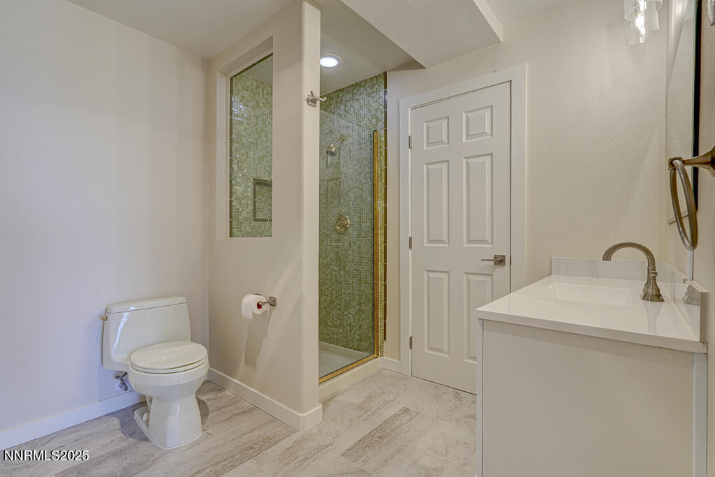 331 Tramway Drive, Unit 17 Stateline, NV 89449 - Photo 15 of 22 a bathroom with a toilet a sink and a mirror