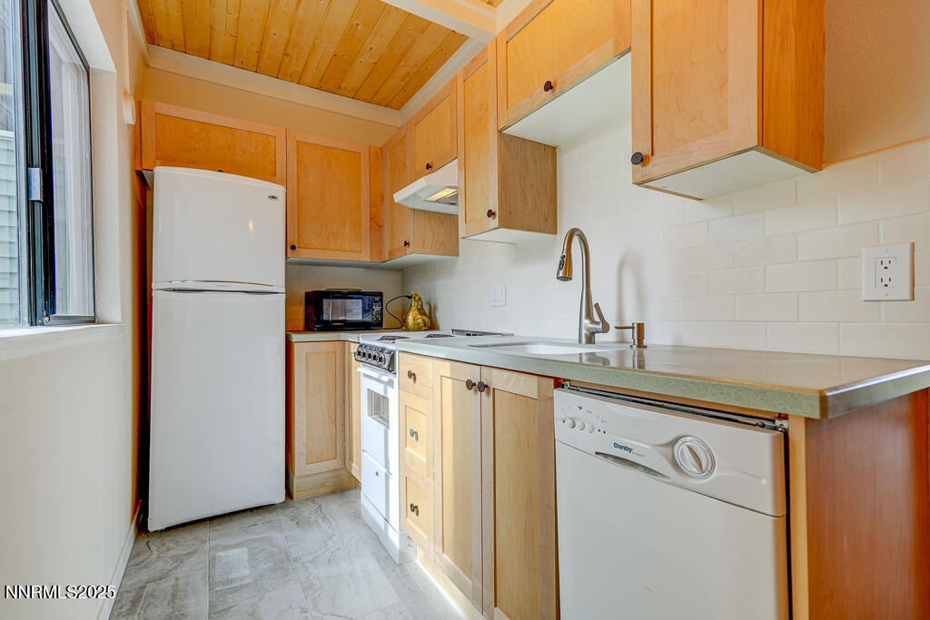 331 Tramway Drive, Unit 17 Stateline, NV 89449 - Photo 2 of 22 a kitchen with a sink a refrigerator and cabinets