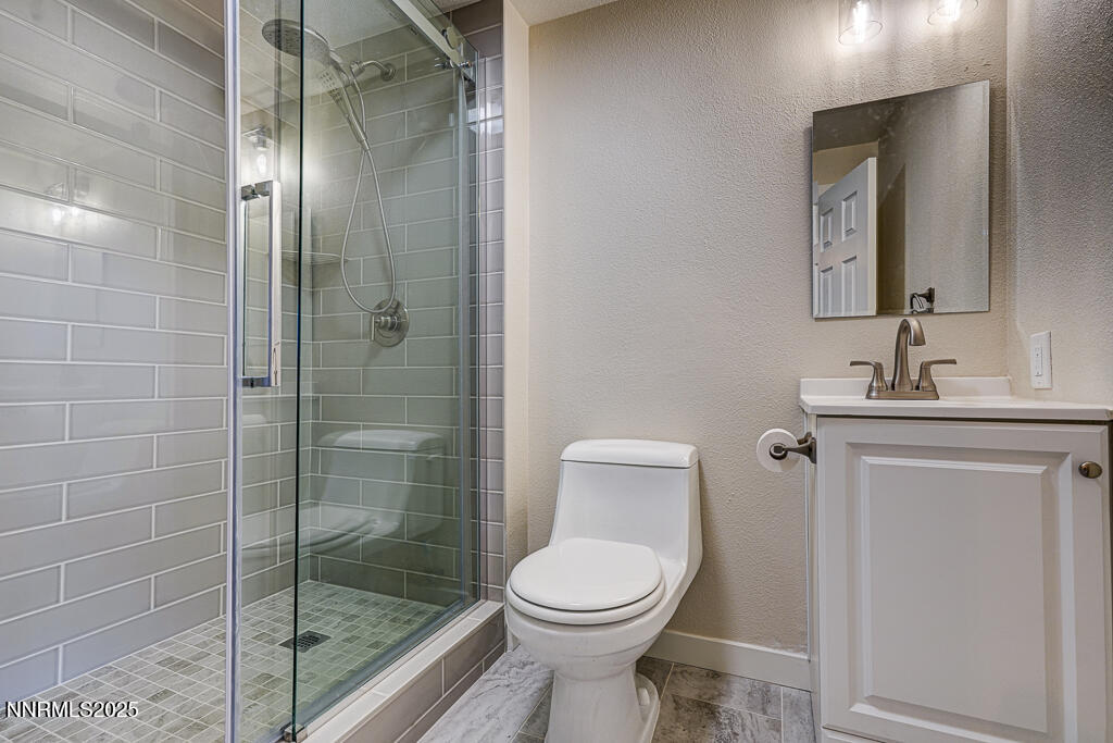 331 Tramway Drive, Unit 17 Stateline, NV 89449 - Photo 9 of 22 a bathroom with a toilet a sink and shower