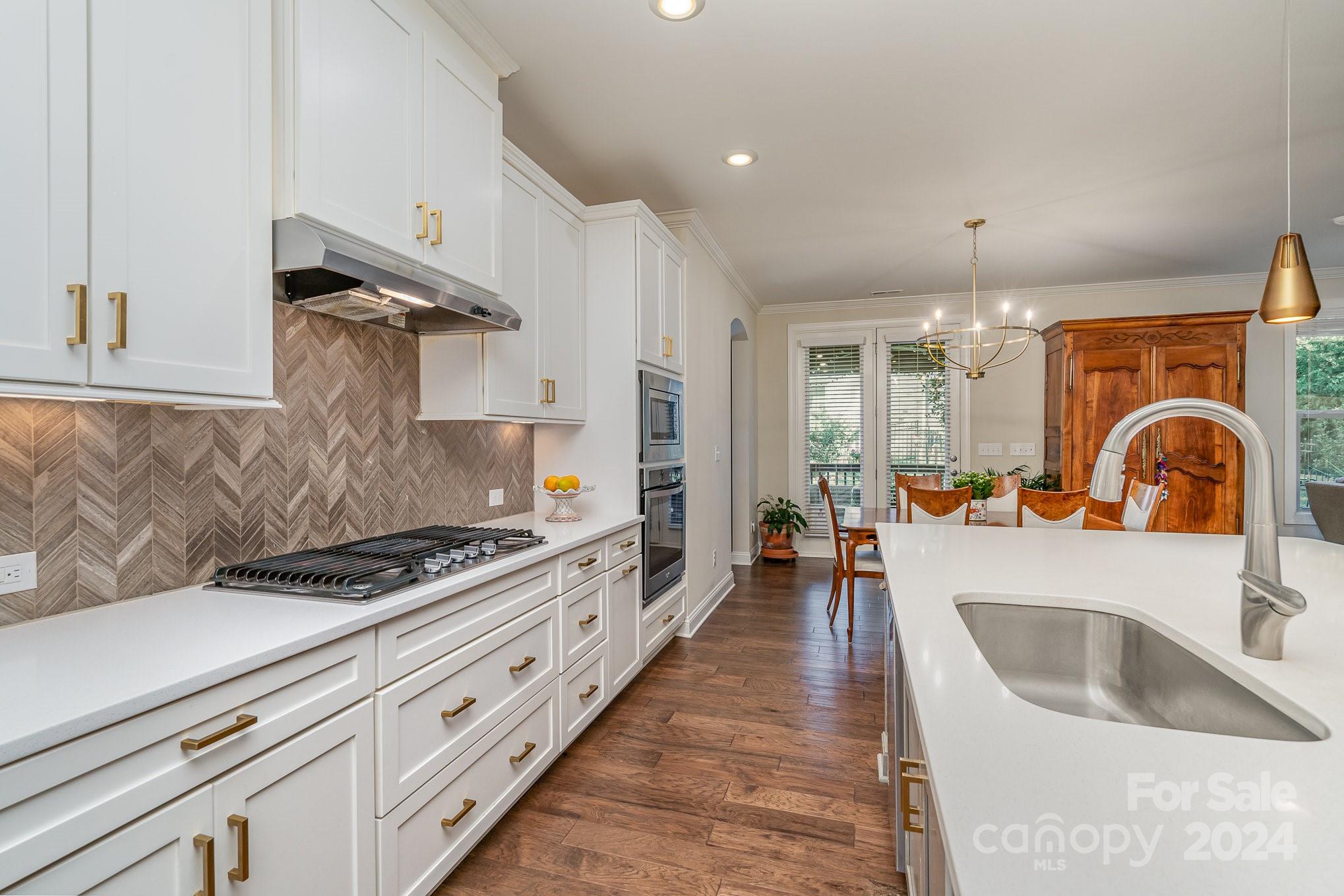 104 Smithfield Drive Charlotte, NC 28270 - Photo 18 of 39 a kitchen with sink stove and cabinets