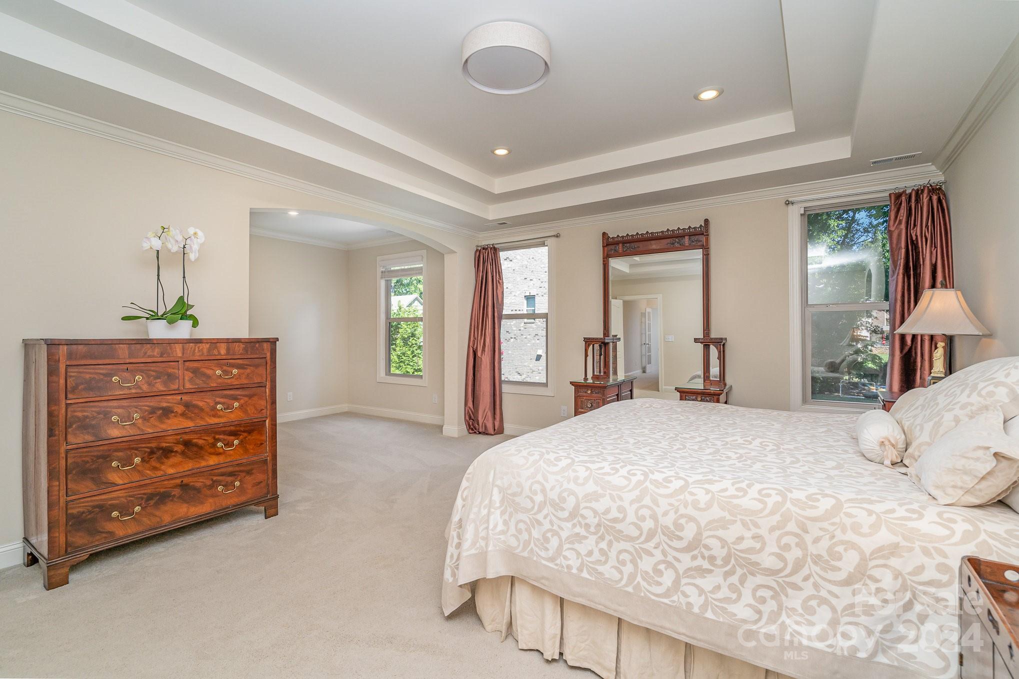 104 Smithfield Drive Charlotte, NC 28270 - Photo 22 of 39 a spacious bedroom with a bed and a dresser
