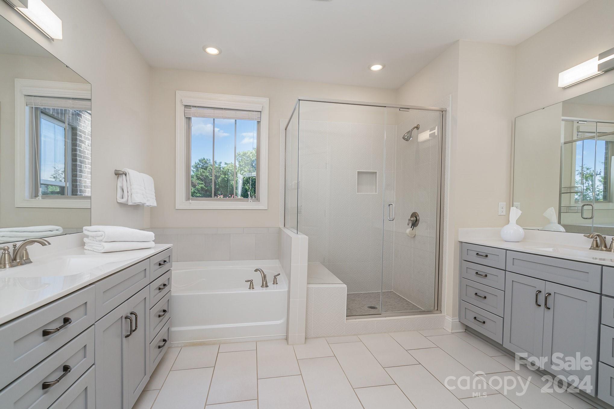 104 Smithfield Drive Charlotte, NC 28270 - Photo 24 of 39 a spacious bathroom with a granite countertop sink a toilet mirror and shower