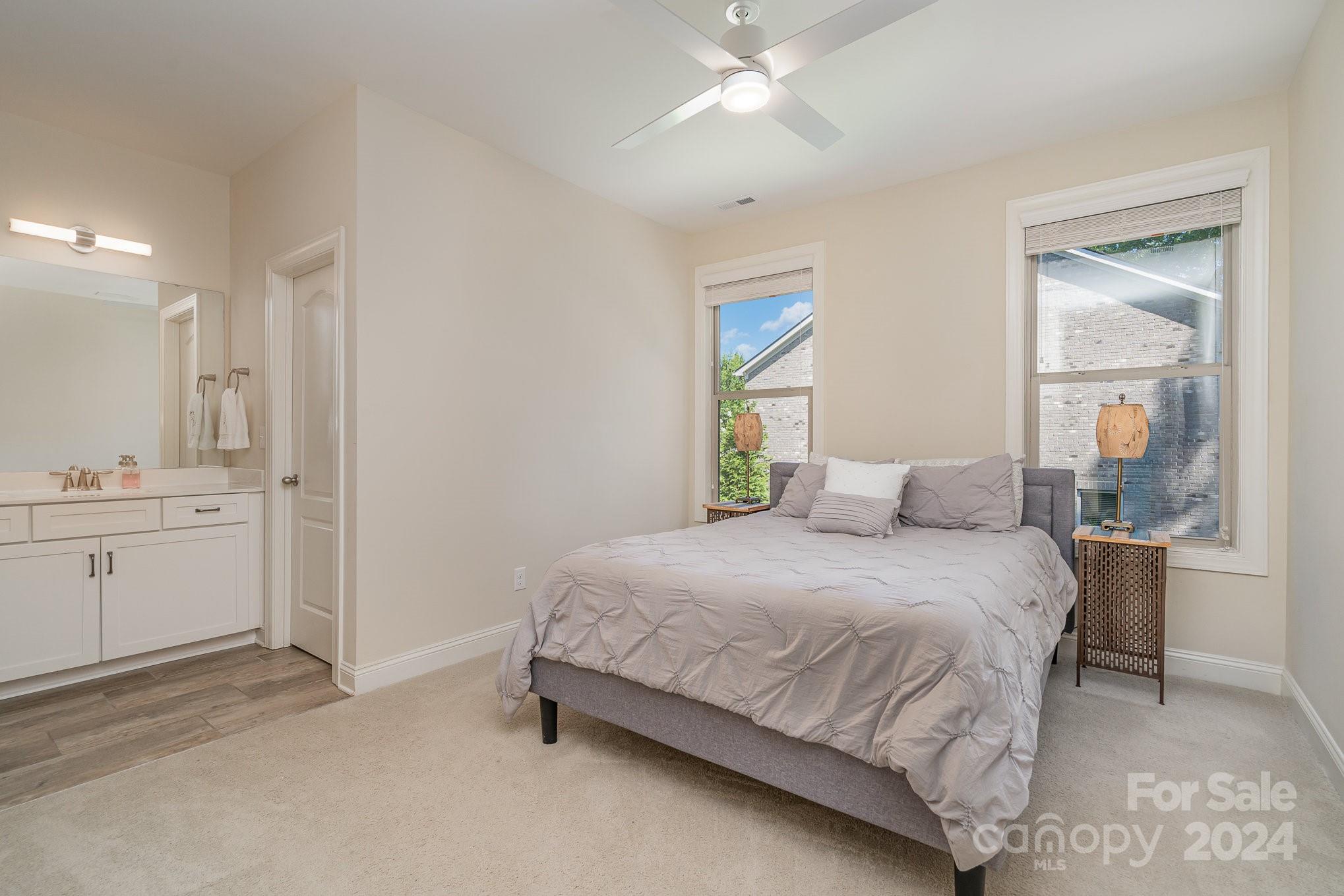 104 Smithfield Drive Charlotte, NC 28270 - Photo 26 of 39 a bedroom with a bed and a chandelier