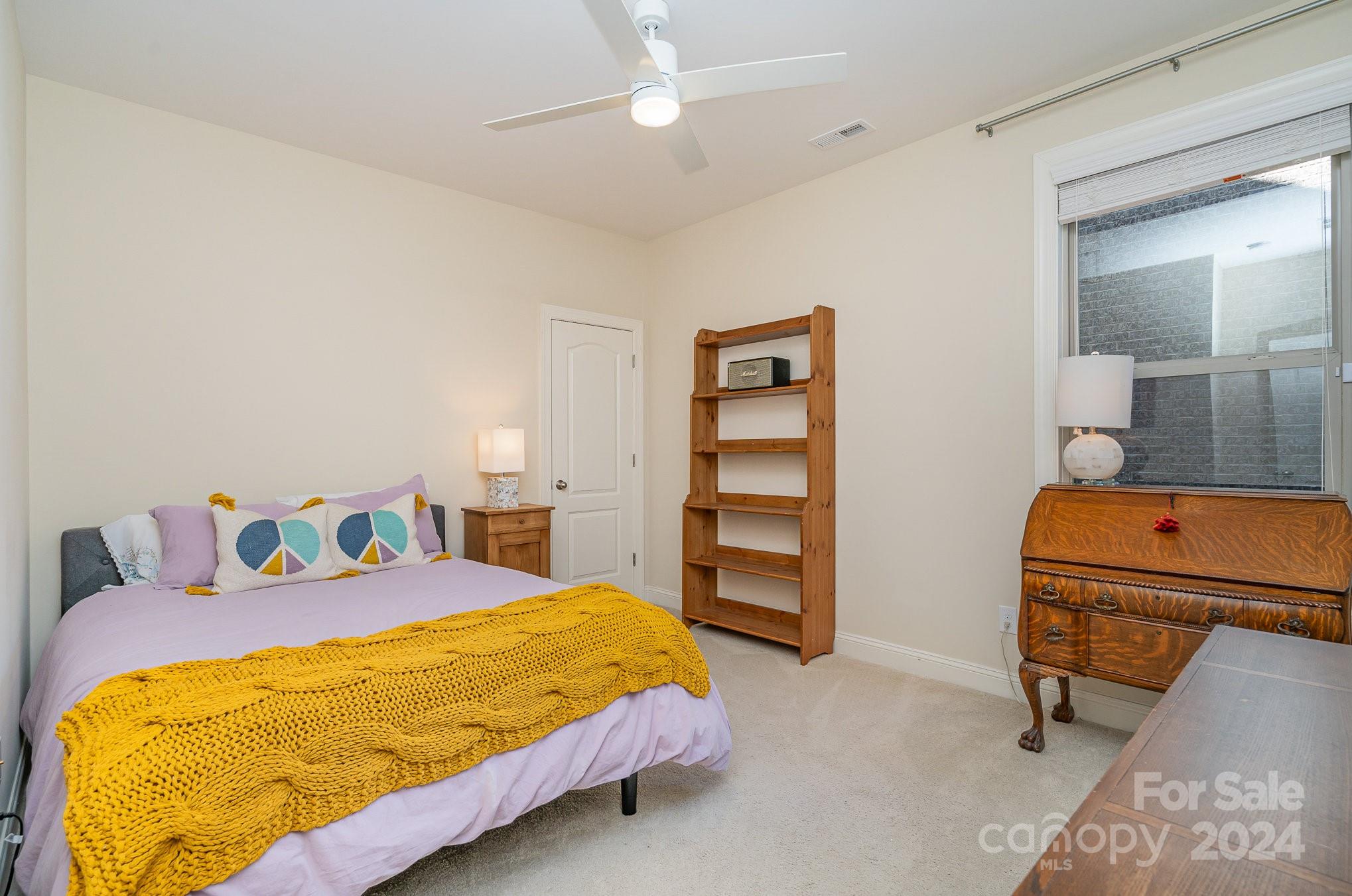 104 Smithfield Drive Charlotte, NC 28270 - Photo 27 of 39 a bedroom with a bed and a chandelier