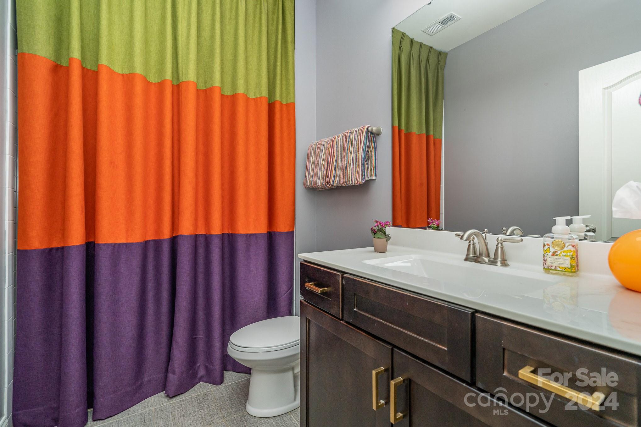 104 Smithfield Drive Charlotte, NC 28270 - Photo 29 of 39 a bathroom with a sink a toilet and a mirror