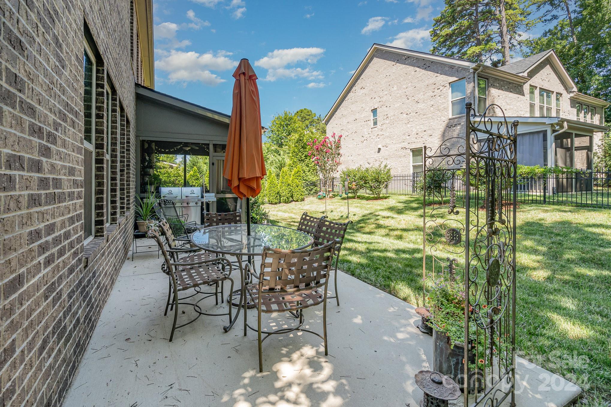 104 Smithfield Drive Charlotte, NC 28270 - Photo 36 of 39 a view of a patio with table and chairs and potted plants