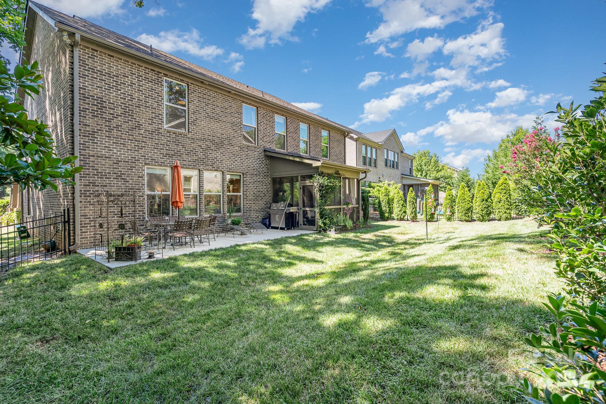 104 Smithfield Drive Charlotte, NC 28270 - Photo 39 of 39 a backyard of a house with table and chairs