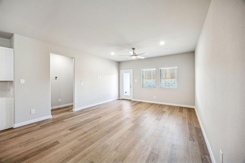 144 Millwood Road Lavon, TX 75166 - Photo 14 of 37 an empty room with wooden floor and windows
