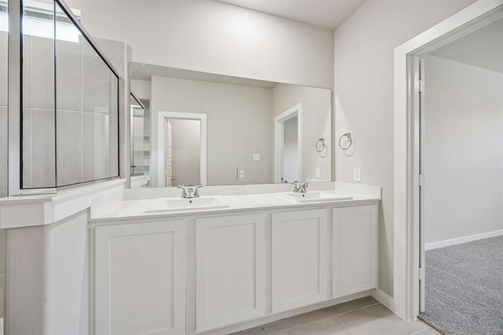 144 Millwood Road Lavon, TX 75166 - Photo 24 of 37 a bathroom with double sink and a large mirror