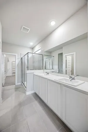 a bathroom with a double vanity sink and mirror