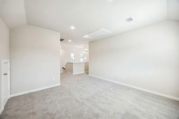 a view of a room with a refrigerator and window