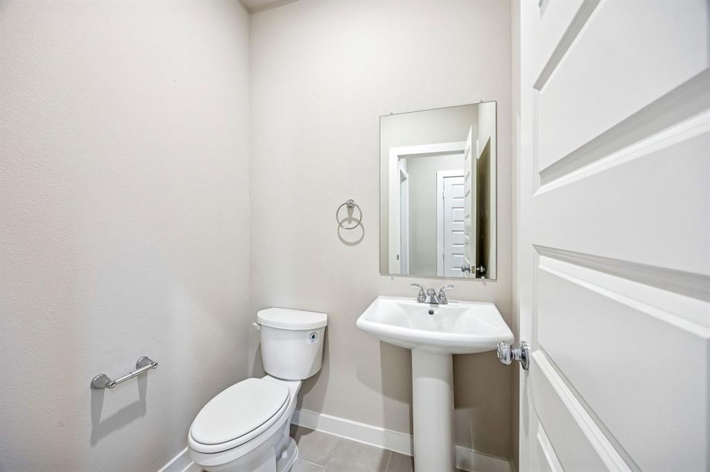 144 Millwood Road Lavon, TX 75166 - Photo 34 of 37 a bathroom with a toilet sink and mirror